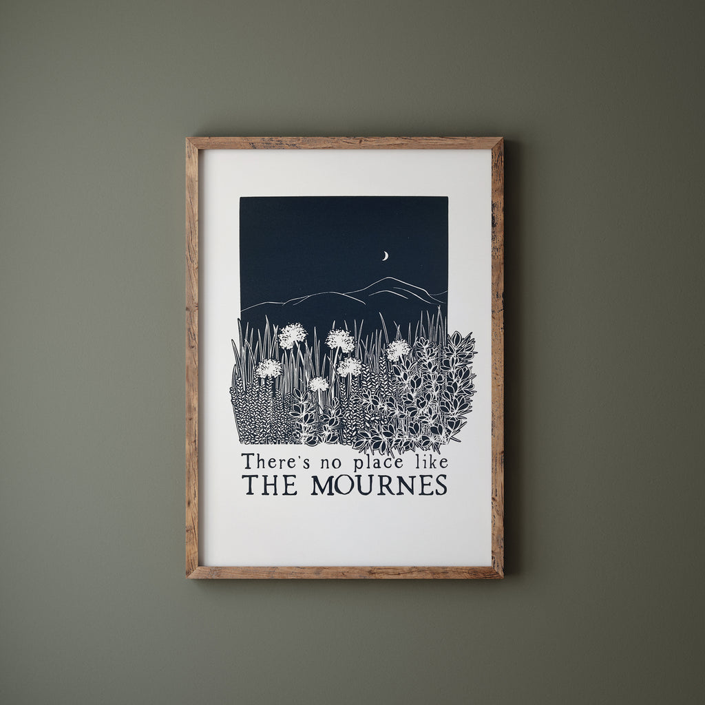 Midnight blue Mournes screen print in a wood frame hanging on a green wall