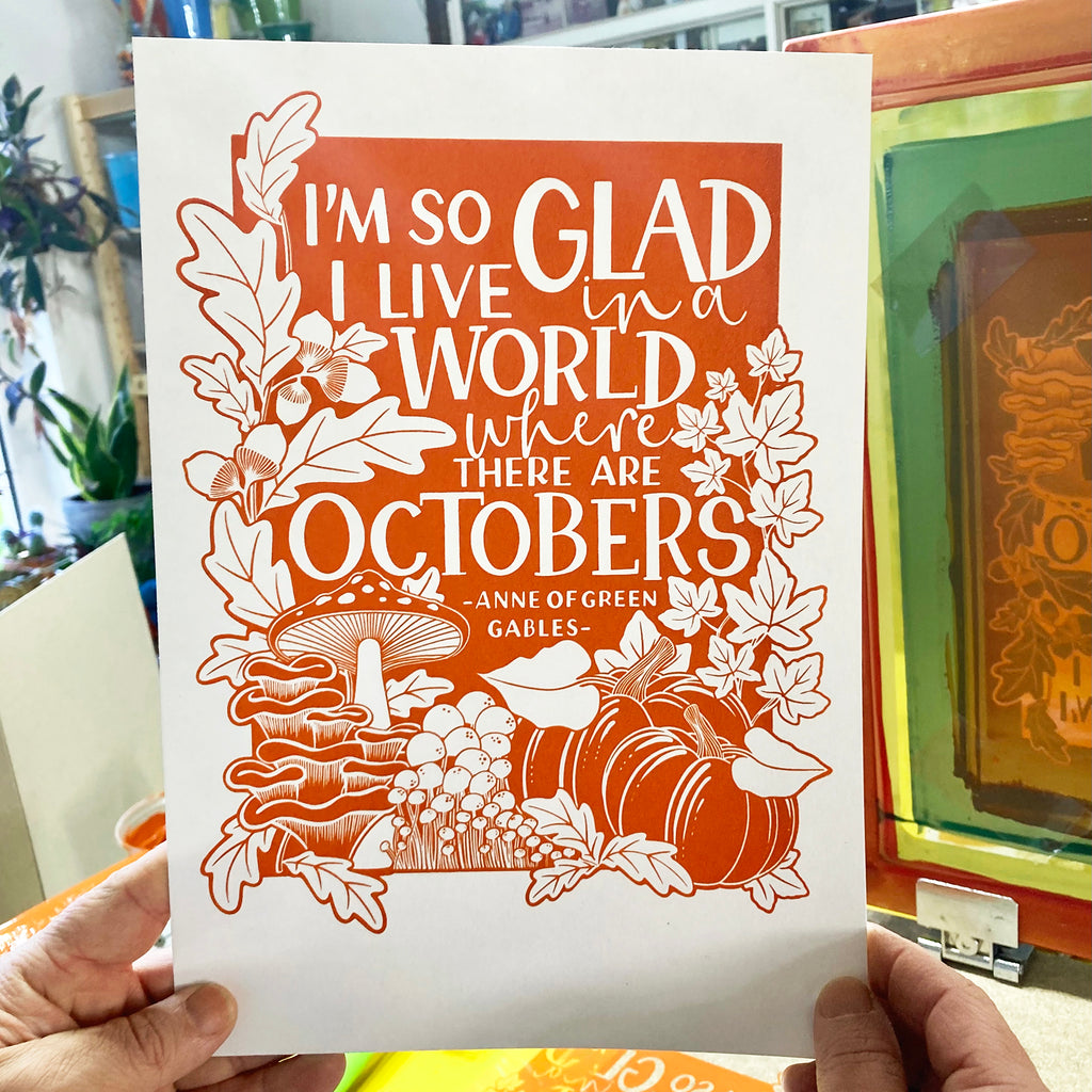 Holding up our newly screen printed Anne of Green Gables screen print with pumpkins, mushrooms and acorns