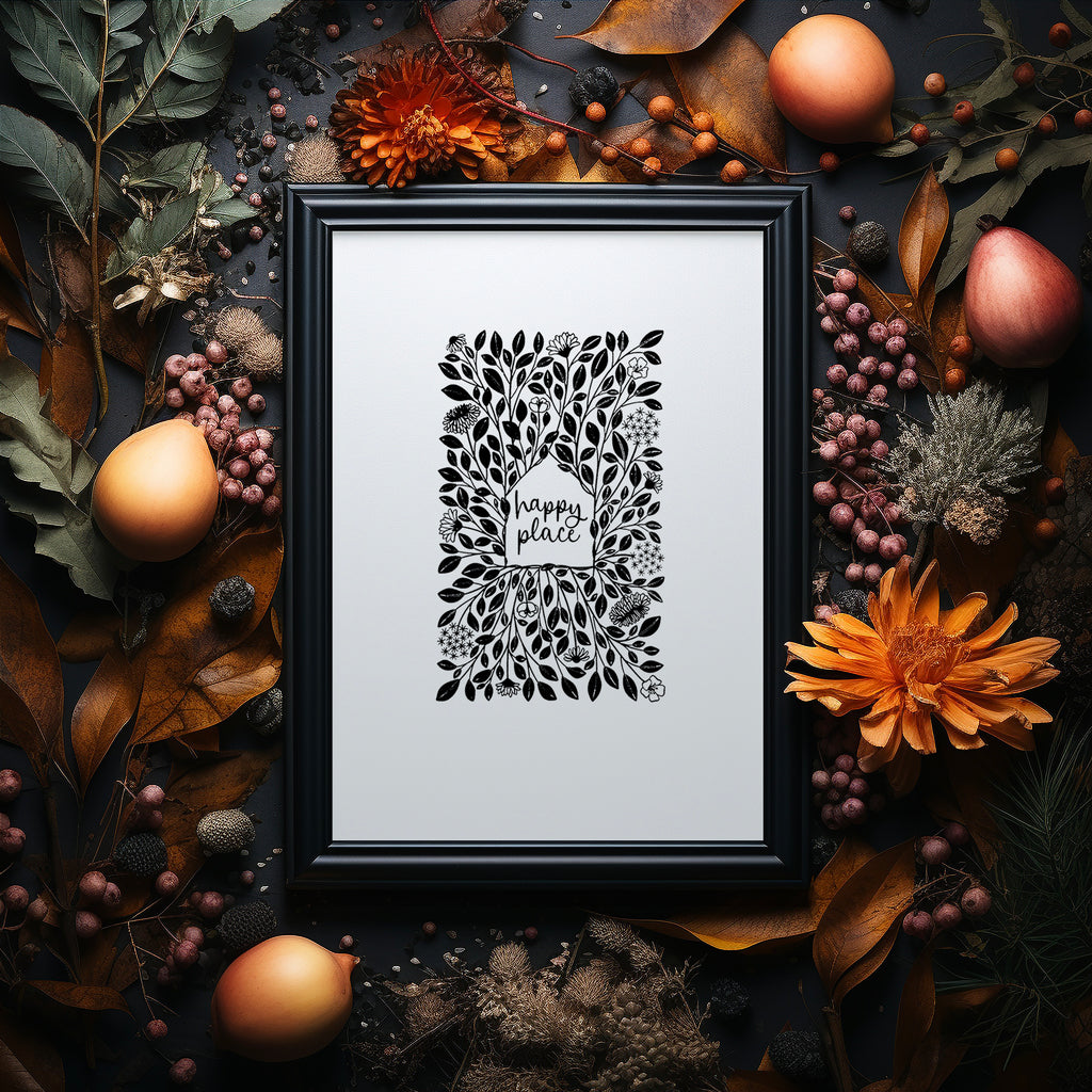 Happy Place screen print in a black frame with a dark background surrounded by Autumnal flowers and foliage