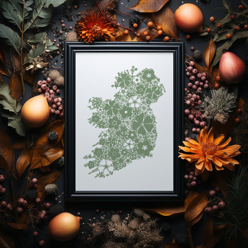 Green floral Ireland screen print in a black frame on a dark background surrounded by Autumnal flowers and foliage