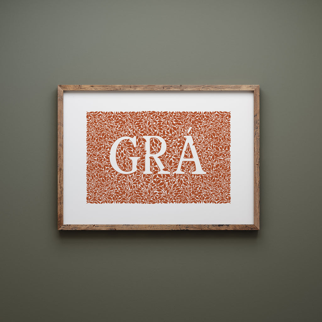 Orange grá screen print in a wood frame hanging on a green wall