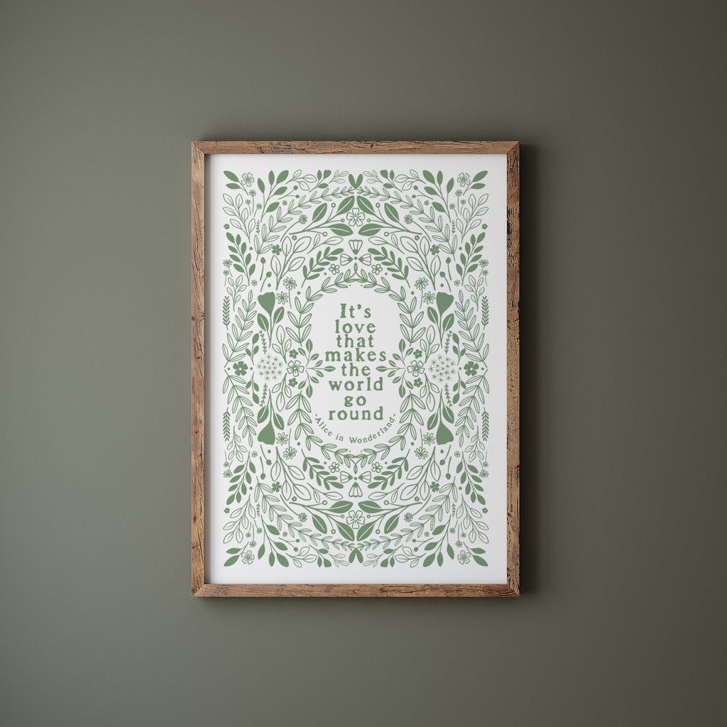 Green and white screen print in a wood frame hanging on a green wall