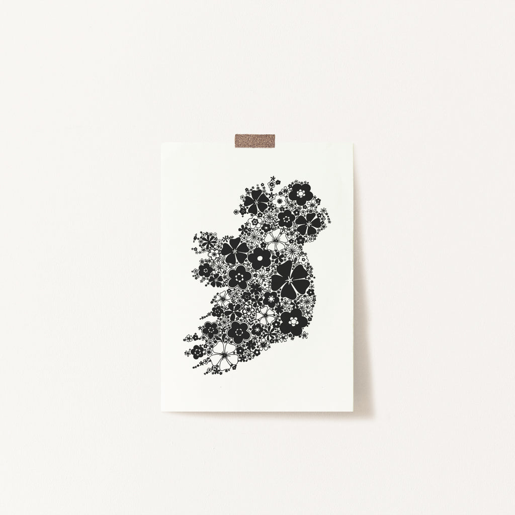 Black floral Ireland screen print stuck to a wall with tape