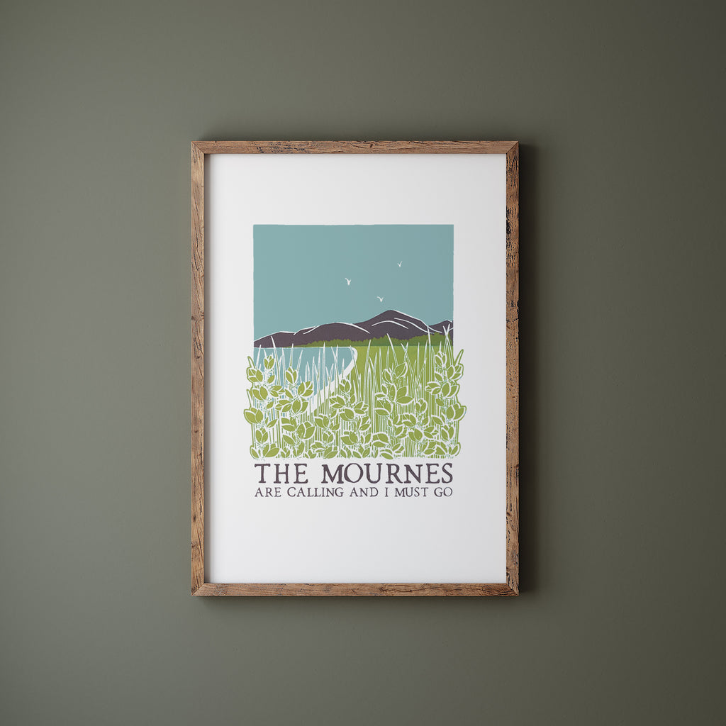 The Mournes are calling screen print in a wood frame hanging on a green wall