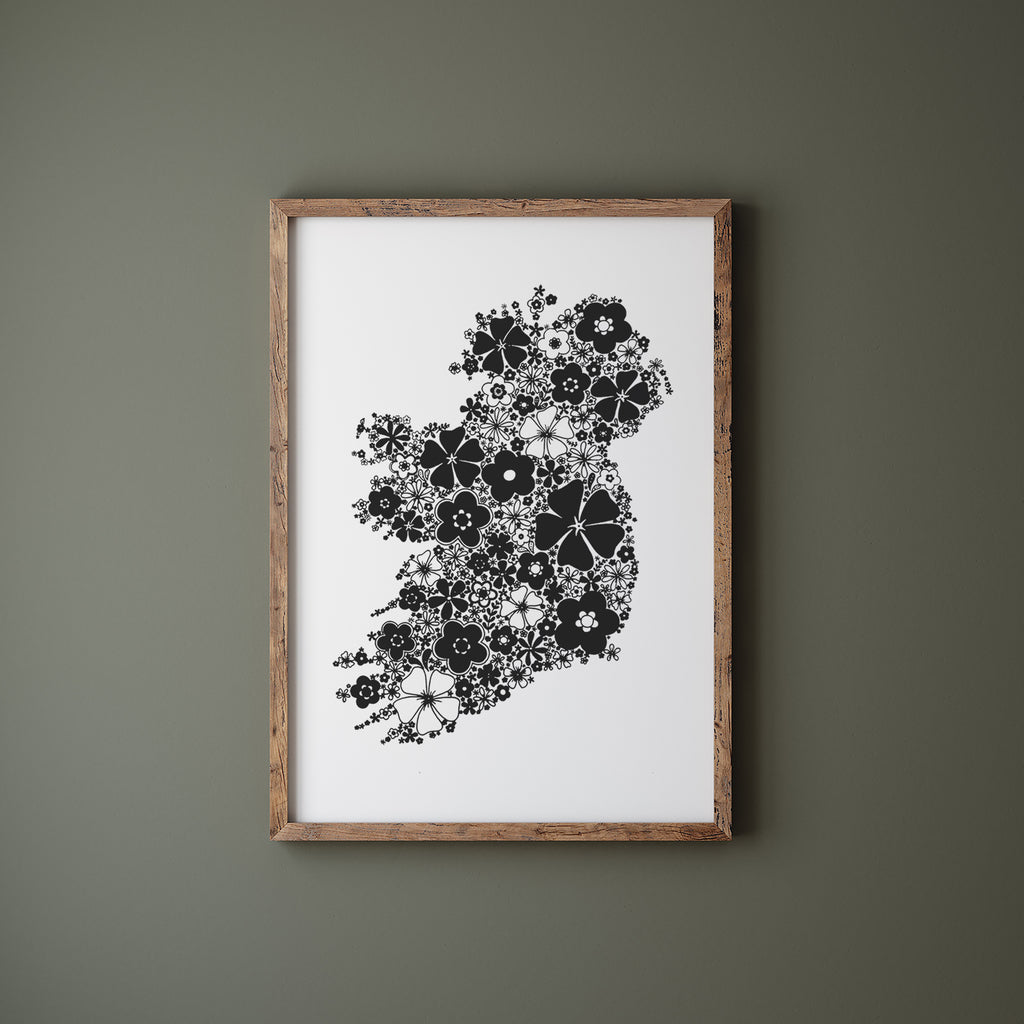 Black floral Ireland in a wood frame hanging on a green wall
