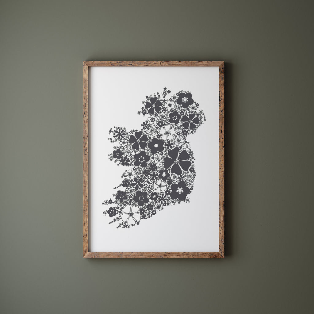 Grey floral Ireland in a wood frame hanging on a green wall