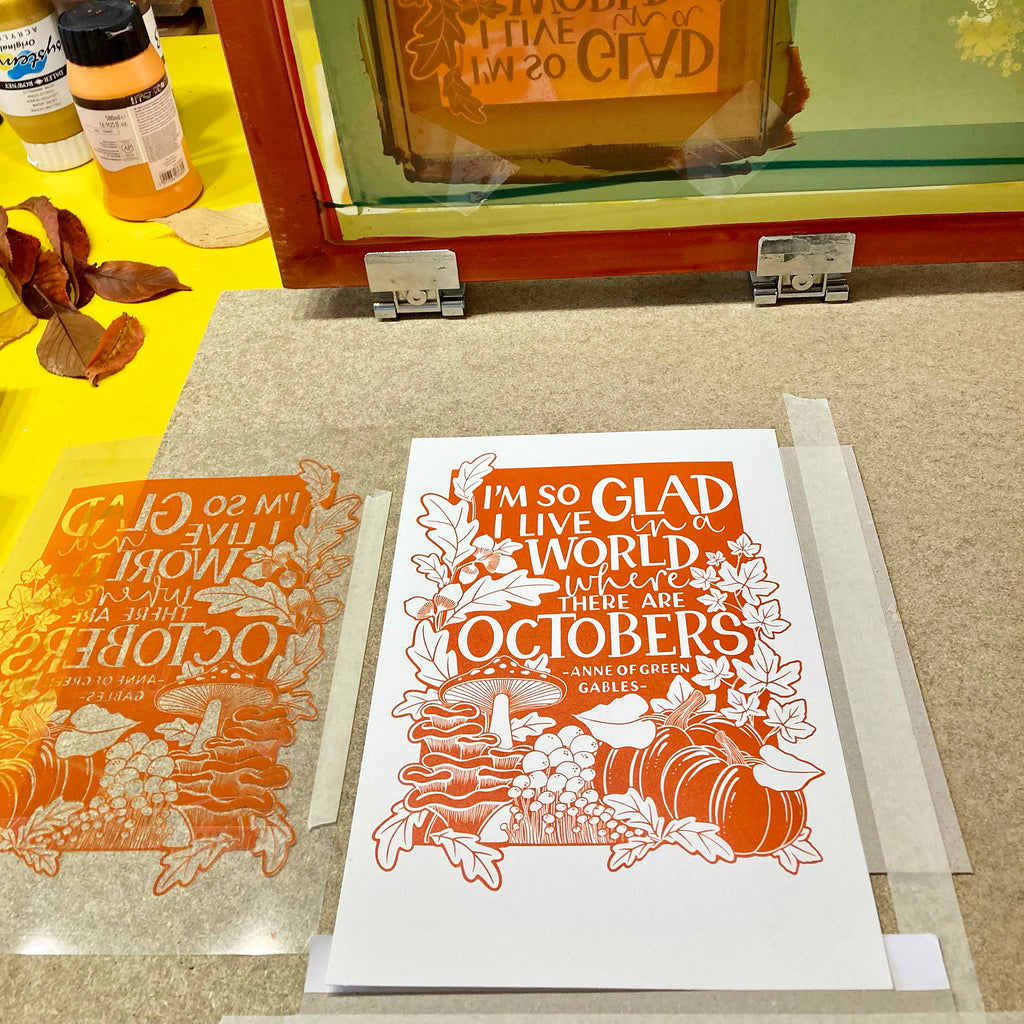 A photo showing our 'I'm so glad I live in a world where there are Octobers' print just screen printed and still on the printing table